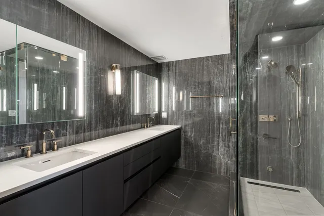 a bathroom with a double vanity sink and mirror