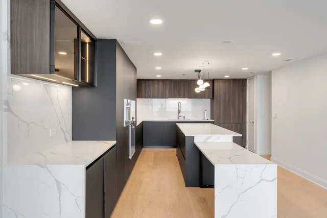 a kitchen with a refrigerator sink and wooden cabinets
