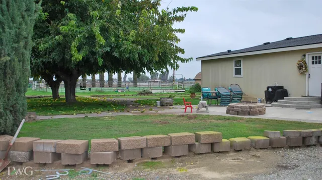 a view of a backyard with sitting area