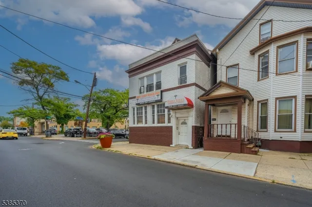 a front view of a house with a street
