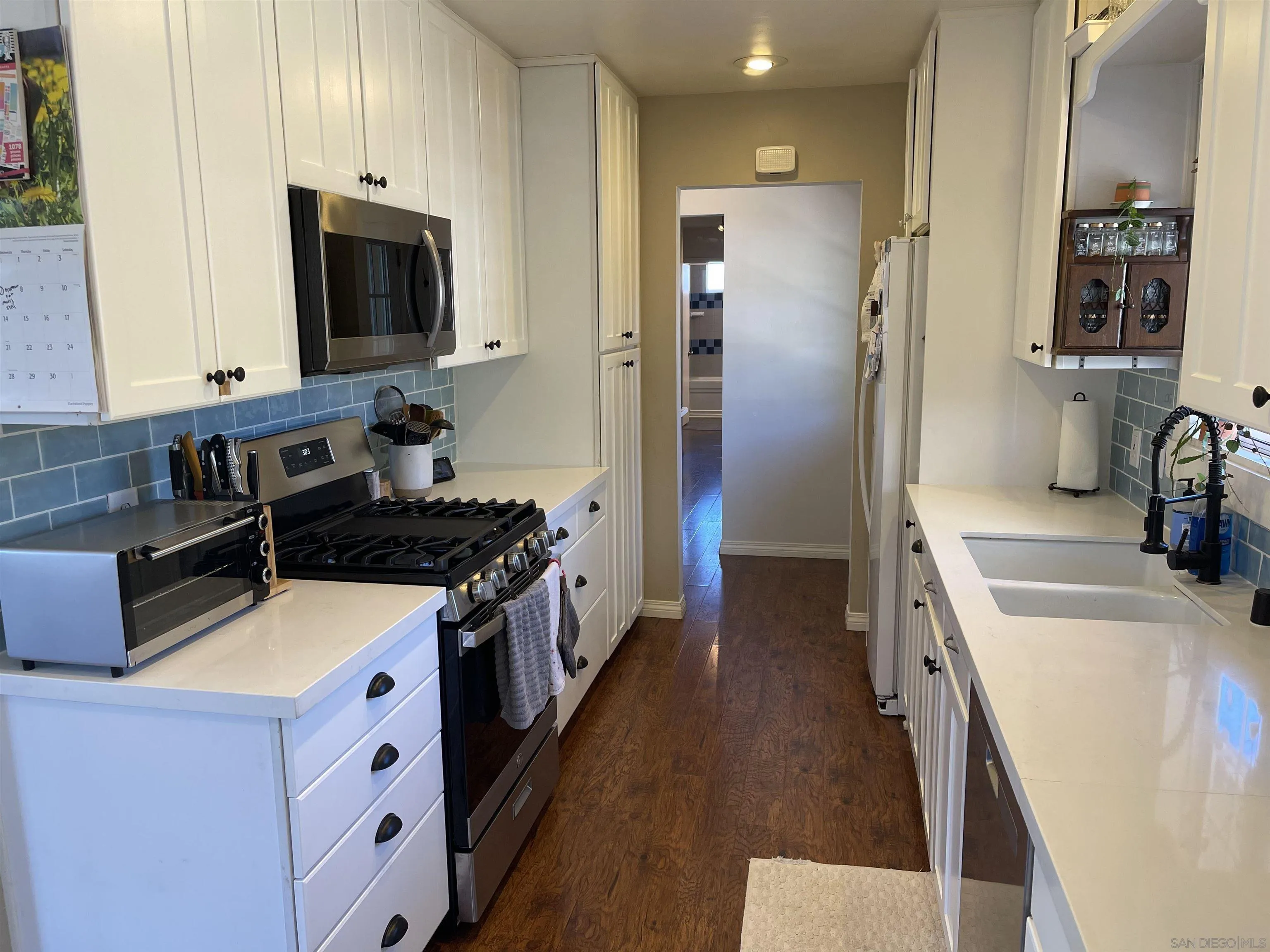 14150 Tobiasson Road Poway, CA 92064 - Photo 4 of 12 a kitchen with stainless steel appliances a stove a sink a refrigerator and a microwave