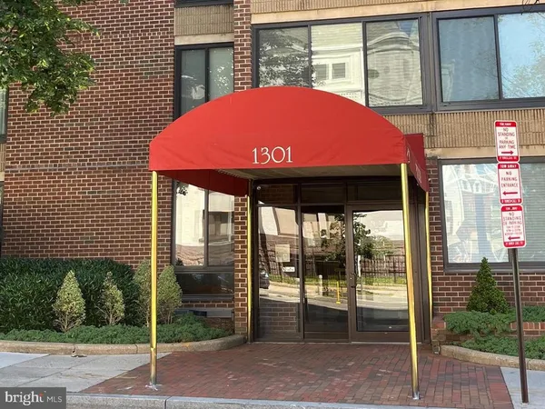 a view of a porch with a table and chairs under an umbrella