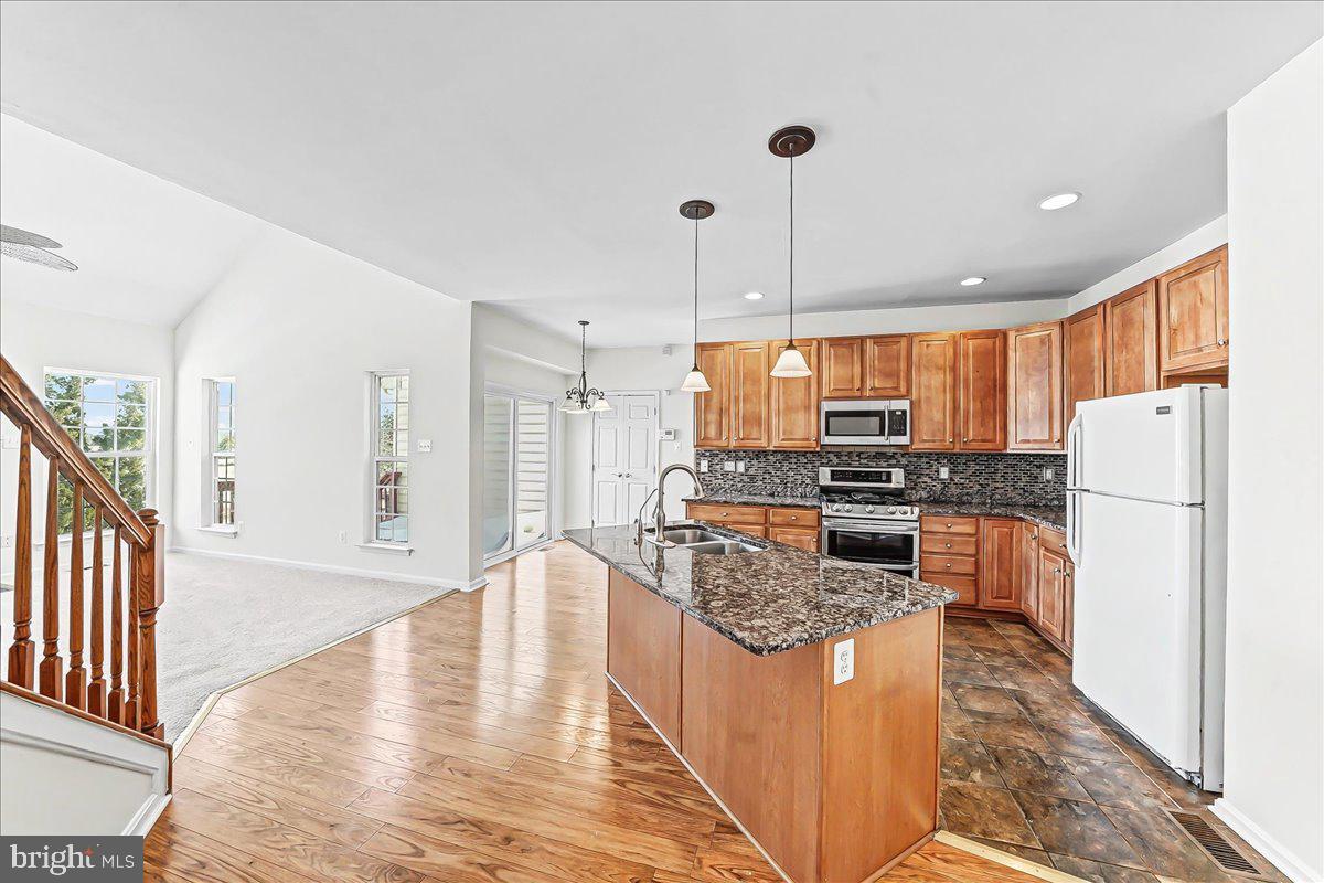 339 Pierce Run Newark, DE 19702 - Photo 12 of 37 a kitchen with stainless steel appliances granite countertop a refrigerator a stove and a wooden floors
