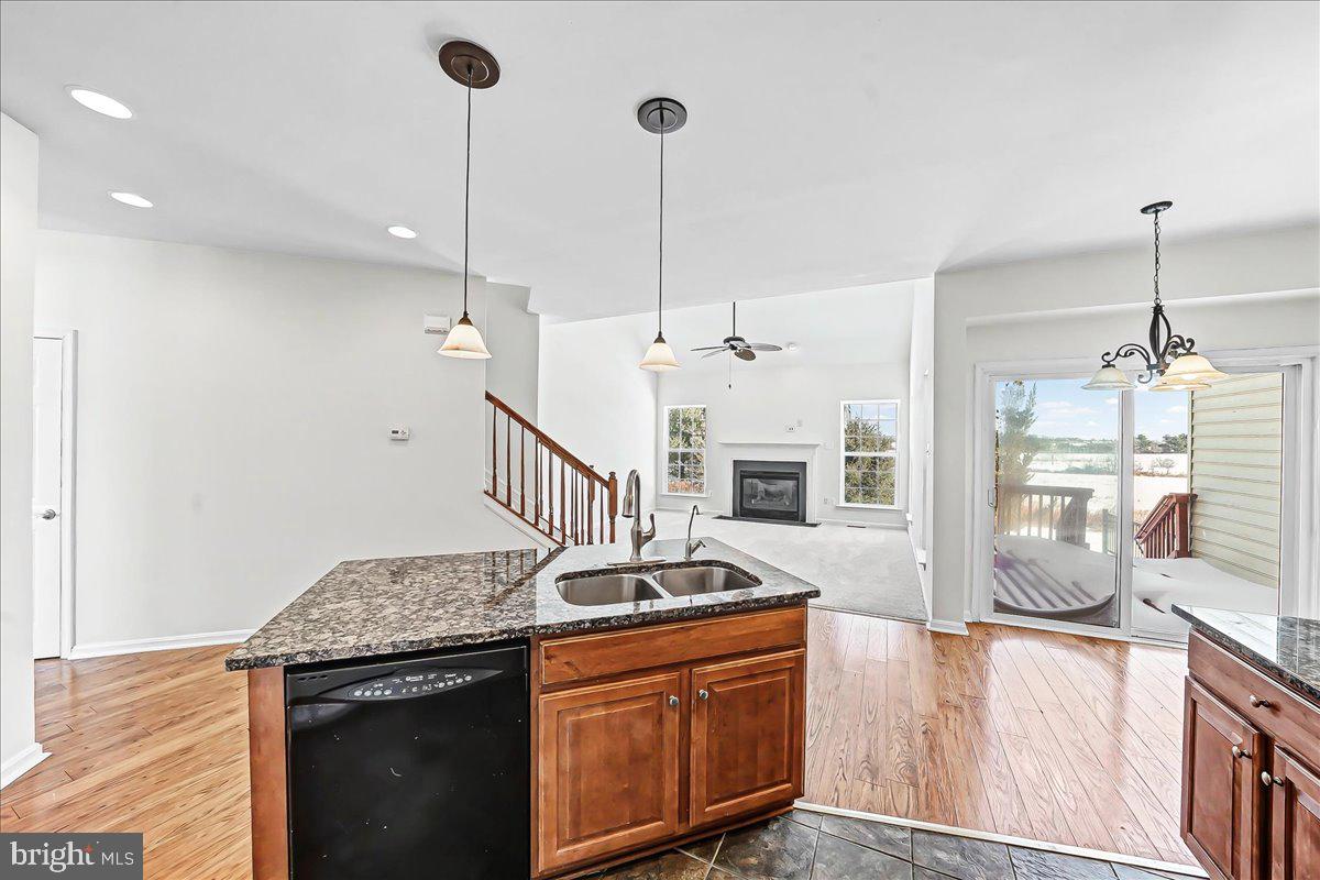 339 Pierce Run Newark, DE 19702 - Photo 13 of 37 a kitchen with stainless steel appliances granite countertop a sink a stove and a wooden floors