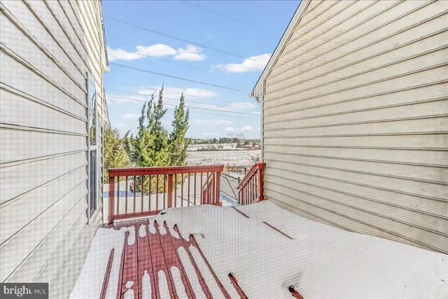 a view of a balcony with chair and wooden floor