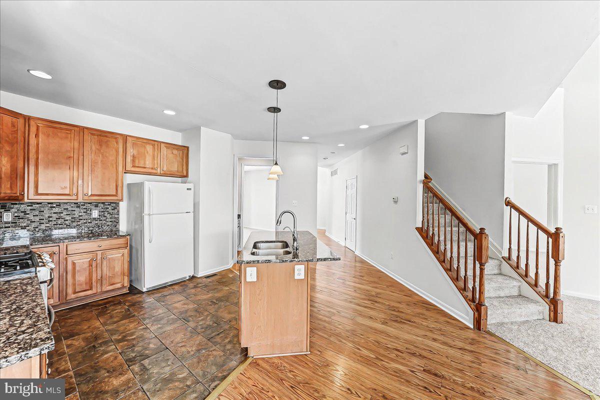 339 Pierce Run Newark, DE 19702 - Photo 9 of 37 a large kitchen with stainless steel appliances kitchen island granite countertop a refrigerator and a stove top oven