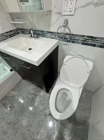 a bathroom with a sink a toilet and a mirror