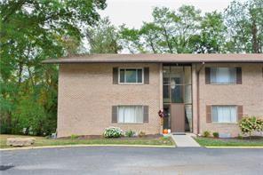 a front view of a house with a yard garage and outdoor seating