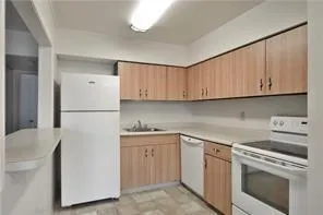 a kitchen with a sink a stove and refrigerator