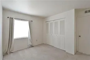 an empty room with a empty space and windows