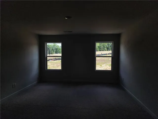 a bathroom with a granite countertop sink a toilet and a mirror