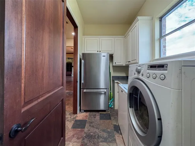a kitchen with refrigerator a washer and dryer