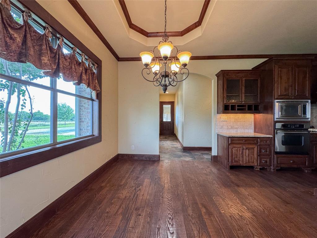 1559 East Blackjack Road East Pilot Point, TX 76258 - Photo 18 of 40 a view of a livingroom with furniture wooden floor and chandelier