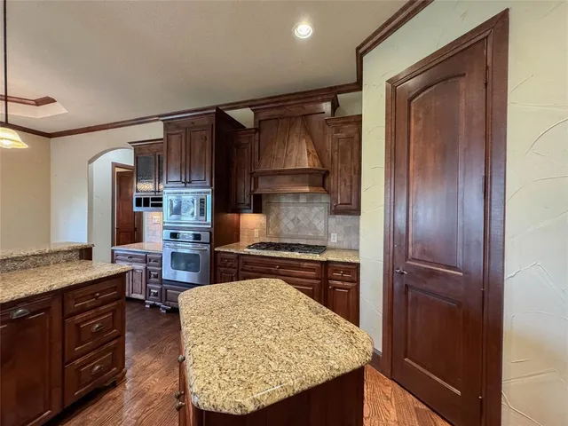 a kitchen with a refrigerator and a stove