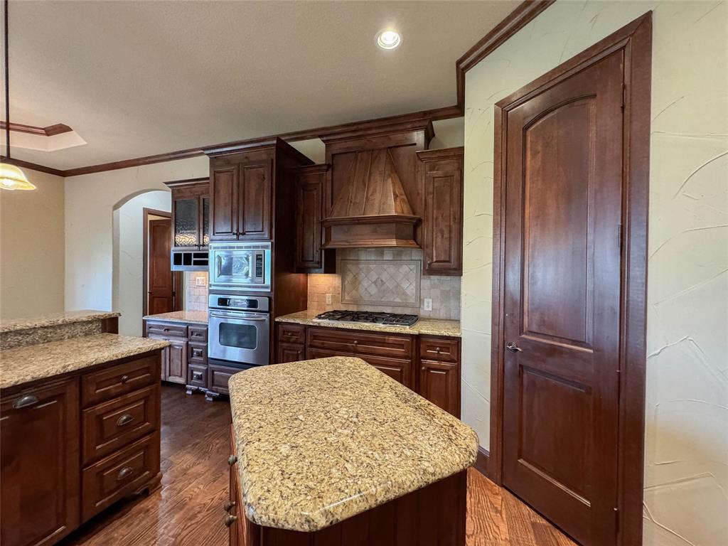 1559 East Blackjack Road East Pilot Point, TX 76258 - Photo 25 of 40 a kitchen with a refrigerator and a stove