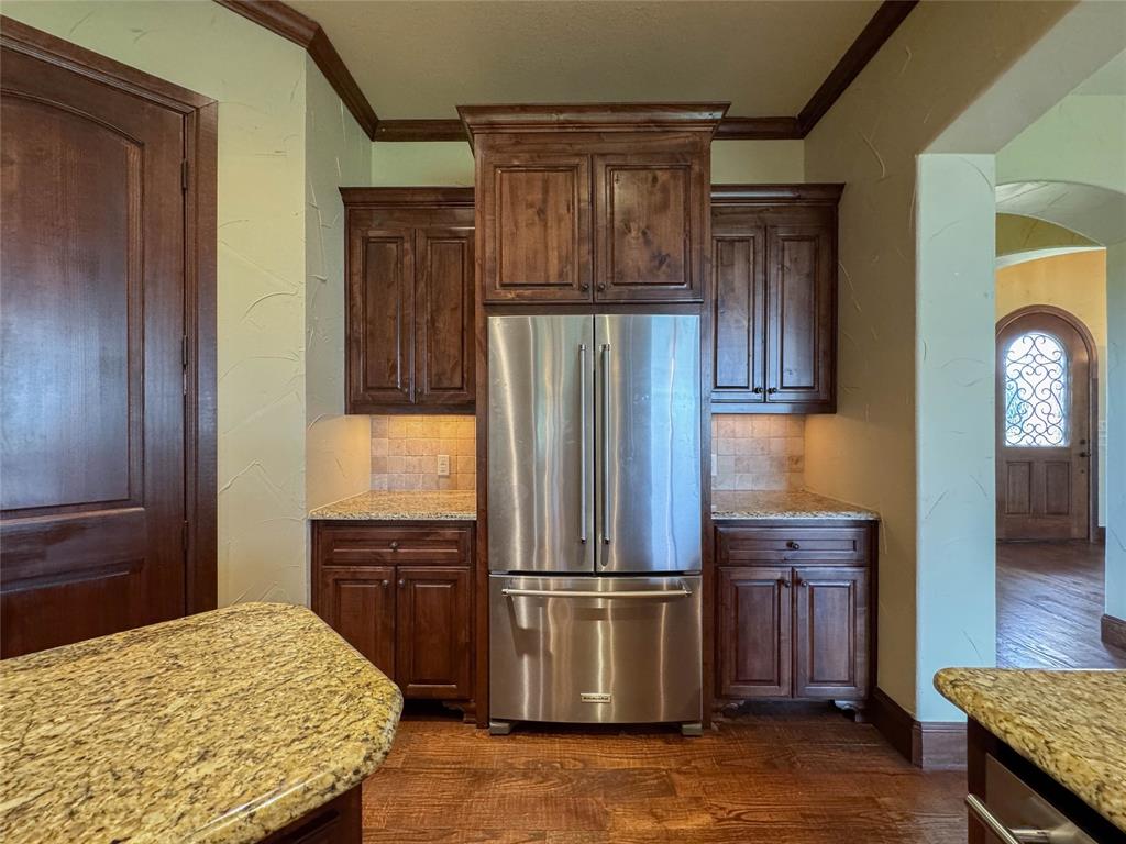 1559 East Blackjack Road East Pilot Point, TX 76258 - Photo 29 of 40 a kitchen with stainless steel appliances granite countertop a refrigerator and a stove