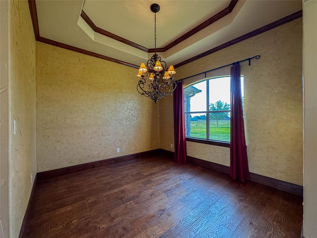 1559 East Blackjack Road East Pilot Point, TX 76258 - Photo 32 of 40 a view of a room with window wooden floor and a ceiling fan