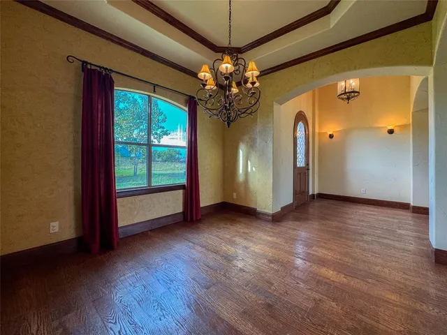 a view of a room with window wooden floor and door