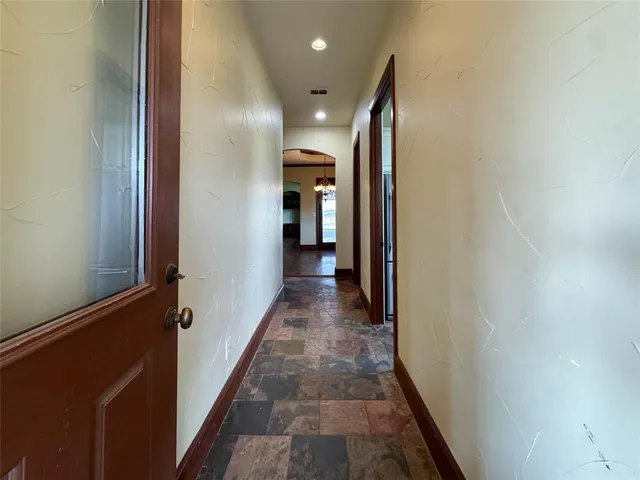a view of hallway with wooden floor