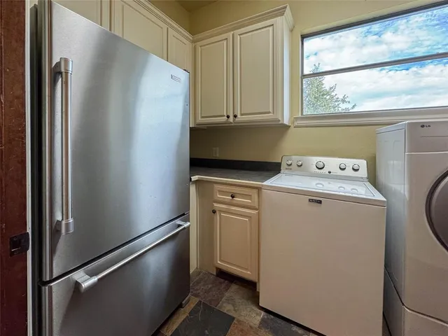 a white refrigerator freezer sitting inside of a kitchen