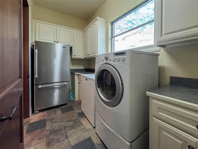 a kitchen with a refrigerator and window