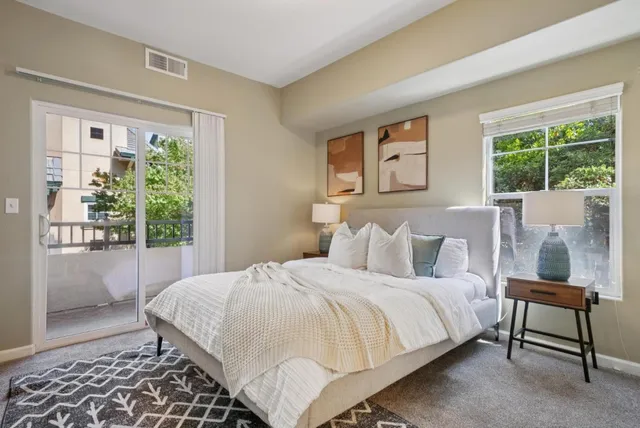 a bedroom with a large bed and a window