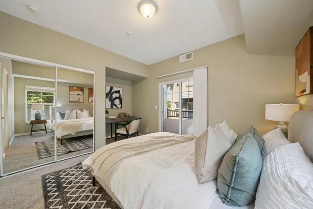 a bedroom with a large bed and a window