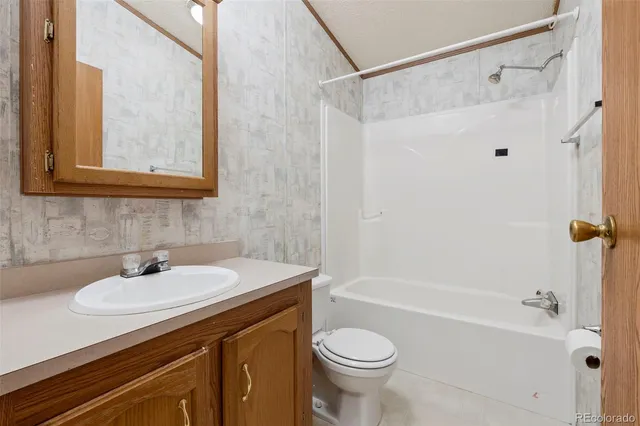 a bathroom with a sink a mirror a toilet and bathtub