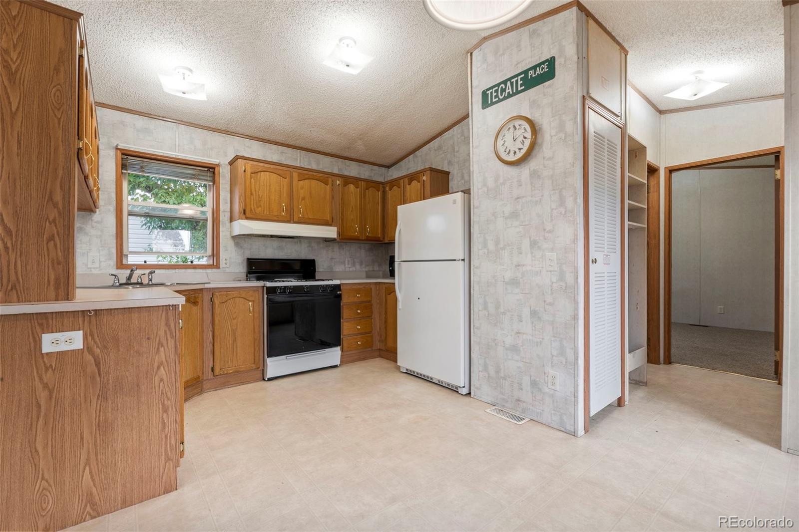 75 West 4th Avenue Golden, CO 80401 - Photo 8 of 15 a kitchen with a refrigerator a sink and a stove top oven