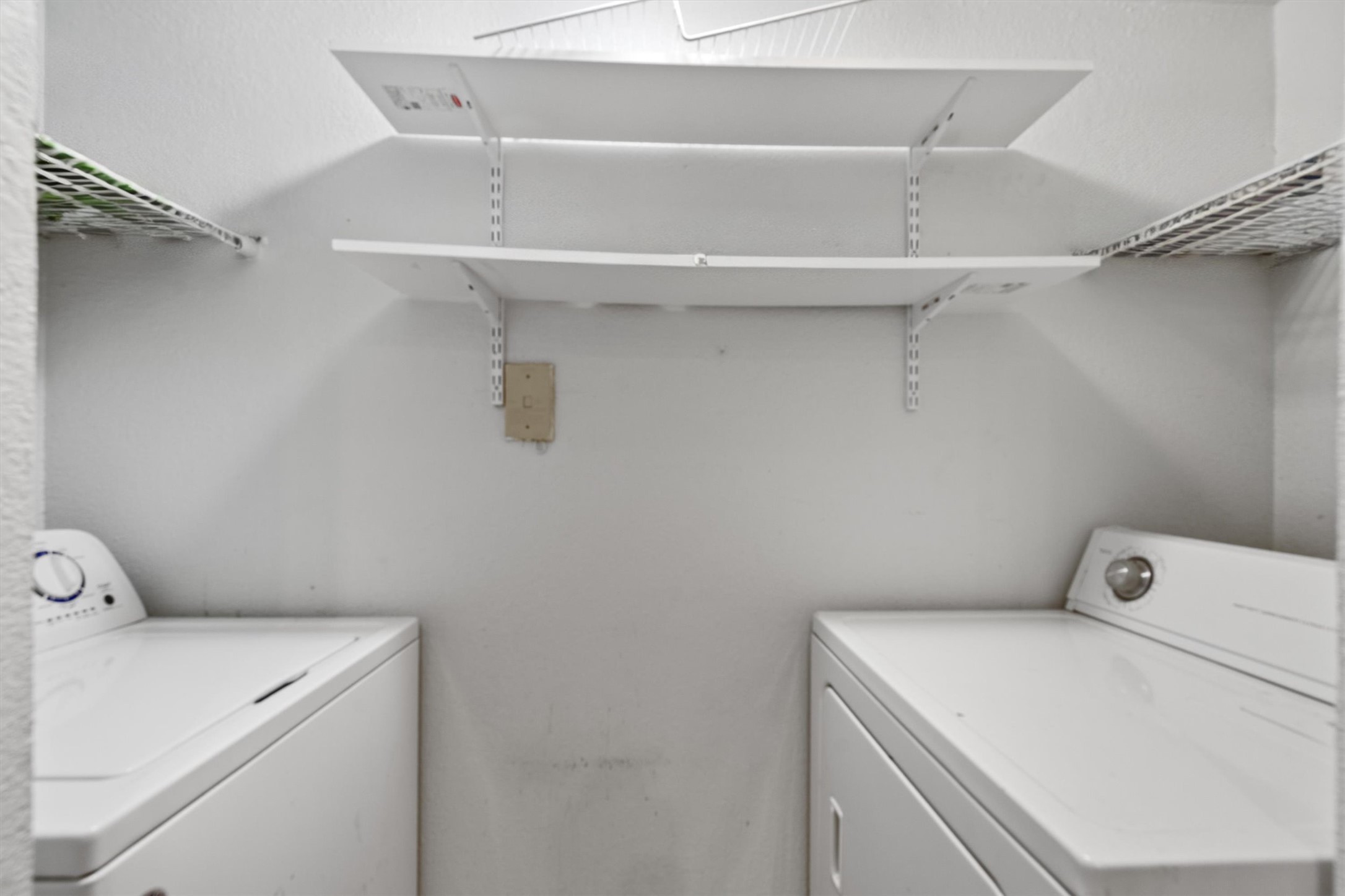 3627 Menchaca Road, Unit 204 Austin, TX 78704 - Photo 14 of 23 Functional laundry nook includes convenient storage shelving above the washer and dryer.