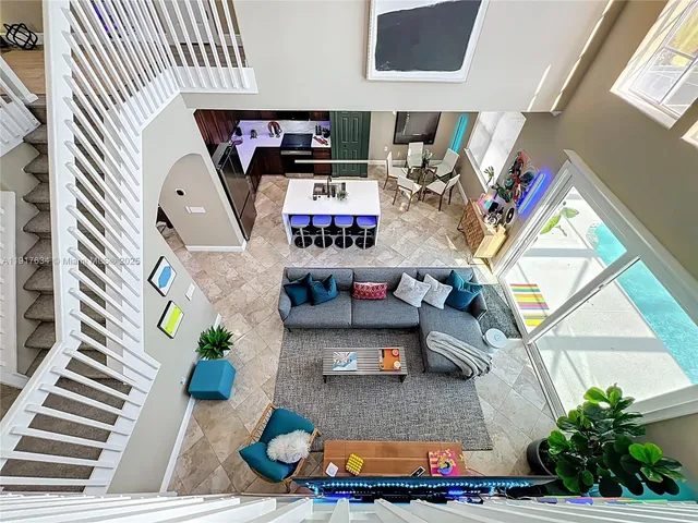 a aerial view of a house with a yard and large trees