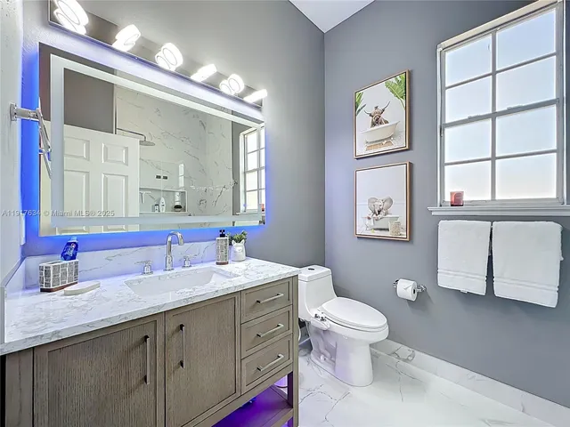 a view of a patio with table and chairs under an umbrella