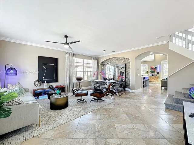 a living room with furniture and a potted plant