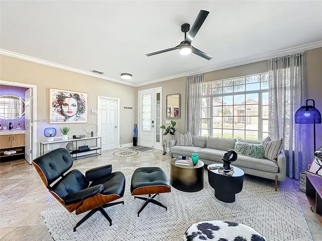 a living room filled with furniture and a chandelier
