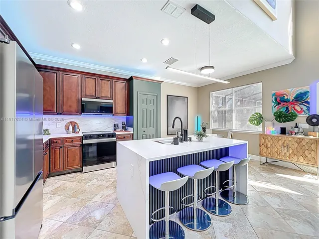 a view of a dining room with furniture and a chandelier