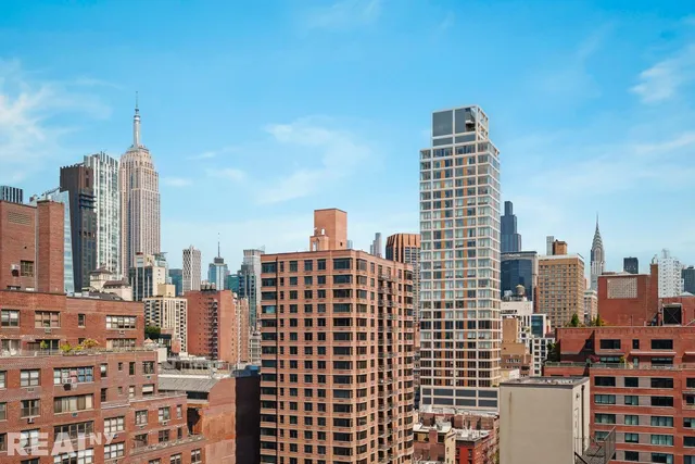 a view of a tall building next to a road
