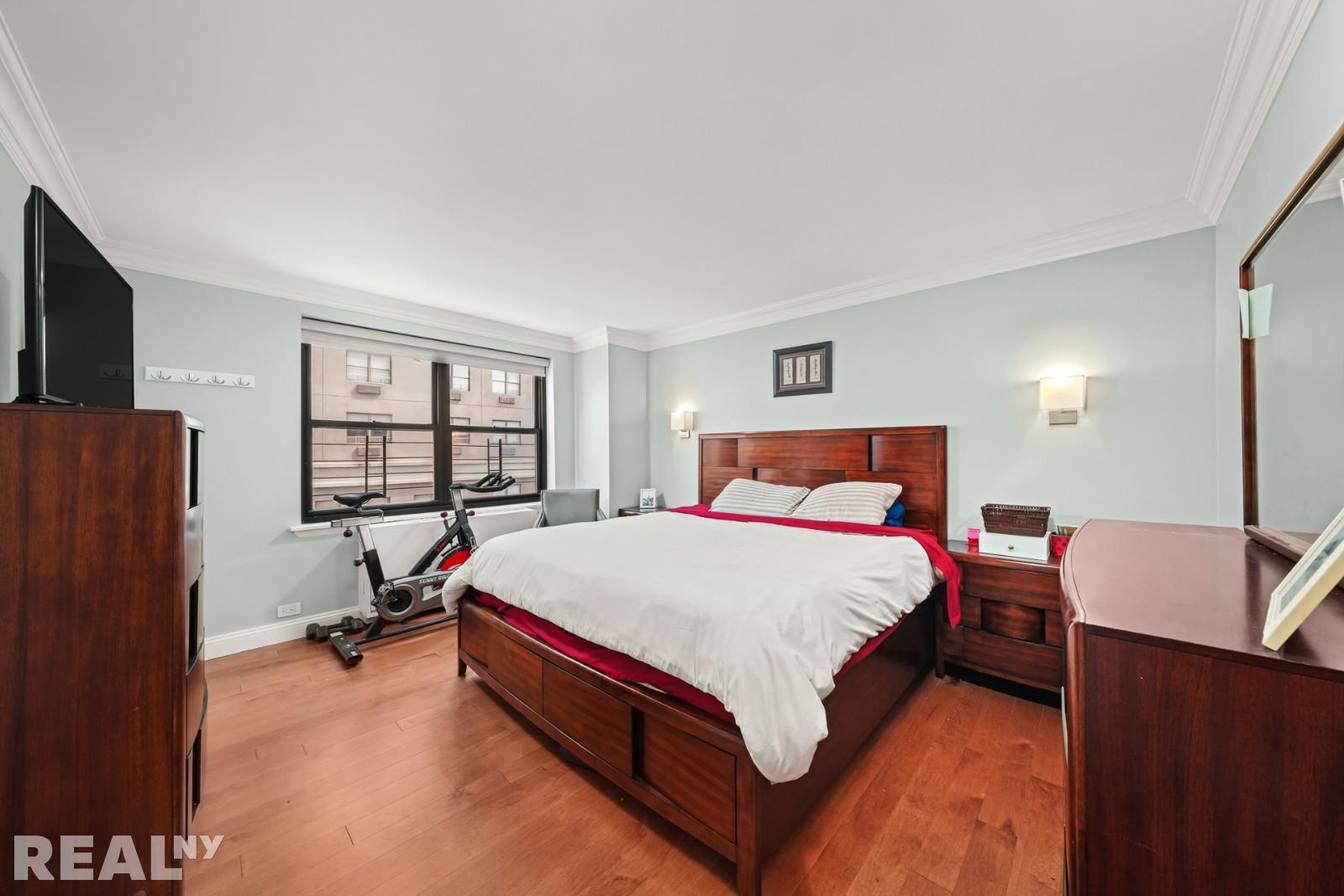 200 East 24th Street, Unit 706 Manhattan, NY 10010 - Photo 4 of 17 a bed room with a bed and a window