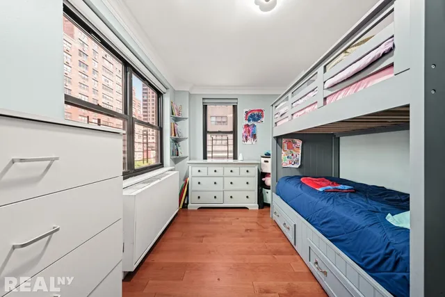 a view of a bedroom with furniture and a window