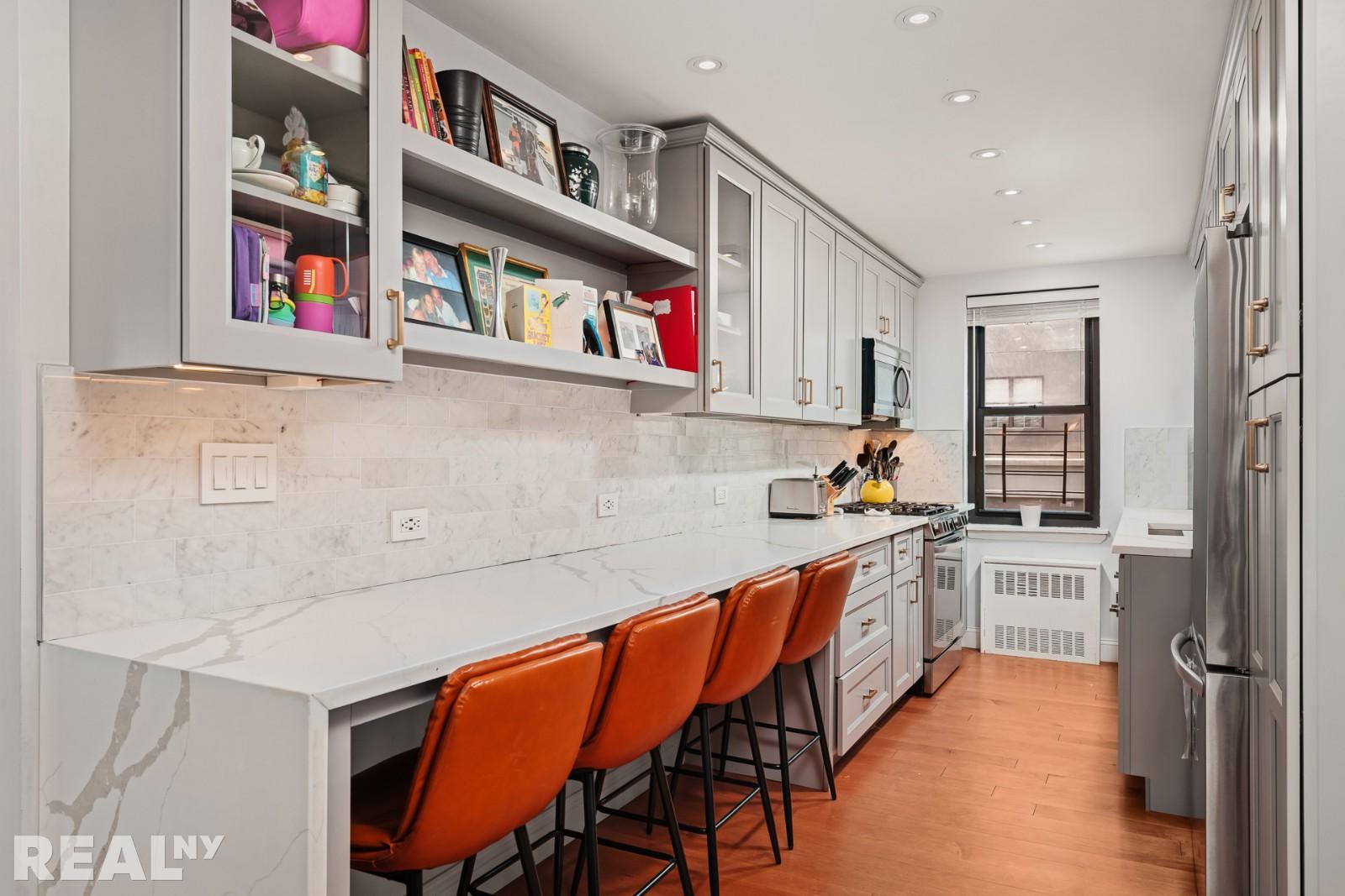 200 East 24th Street, Unit 706 Manhattan, NY 10010 - Photo 10 of 17 a kitchen with stainless steel appliances granite countertop a stove and cabinets
