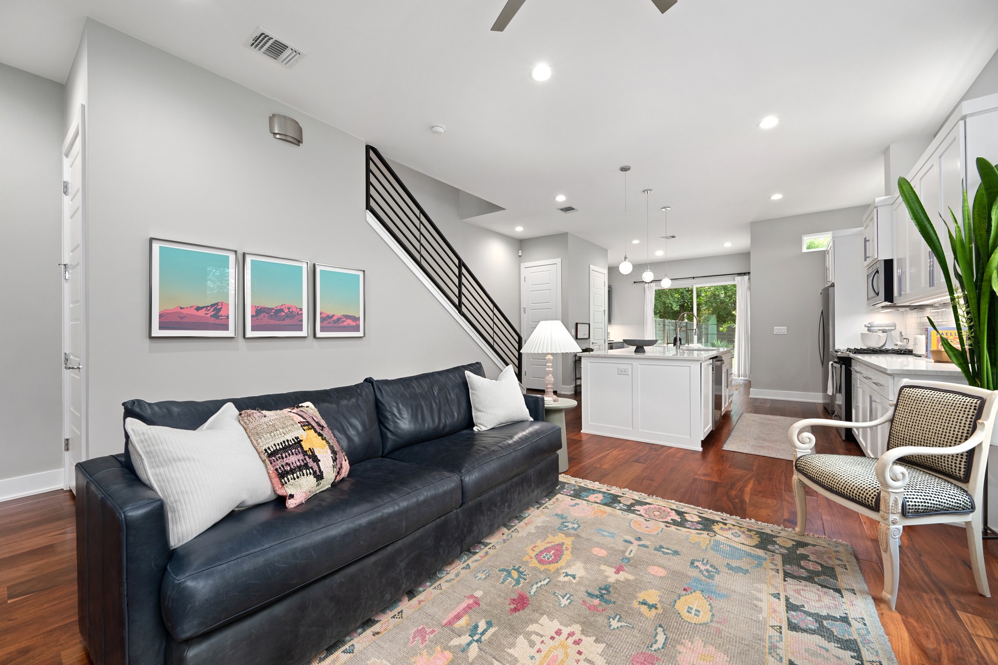 1103 Saucedo Street, Unit 1 Austin, TX 78721 - Photo 10 of 40 An open concept living area seamlessly connects to a contemporary kitchen, boasting rich hardwood floors throughout.