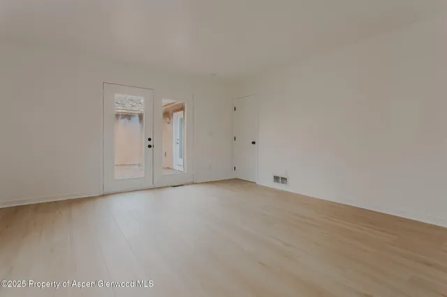 a view of an empty room and wooden floor