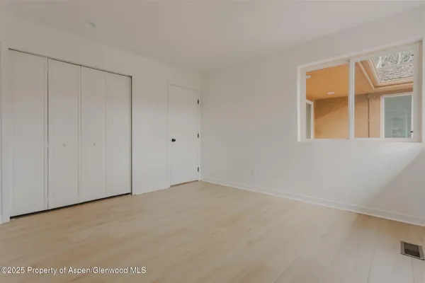 a view of an empty room with a window