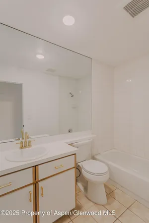 a bathroom with a sink a toilet and a bathtub