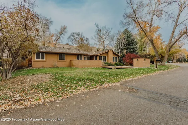 a front view of house with yard and green space