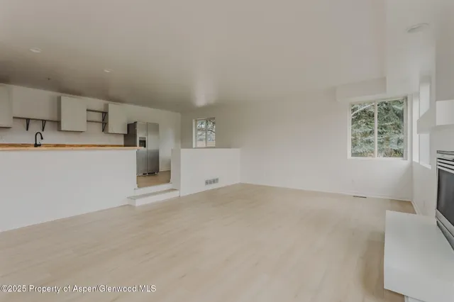a view of a kitchen with a sink cabinets and a wooden floor