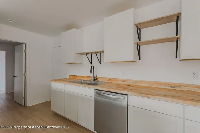 a kitchen with a sink and cabinets