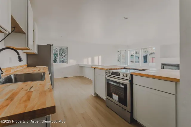 a kitchen with stainless steel appliances granite countertop a stove and a sink