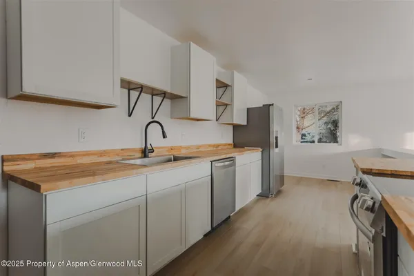 a kitchen with a sink cabinets and window