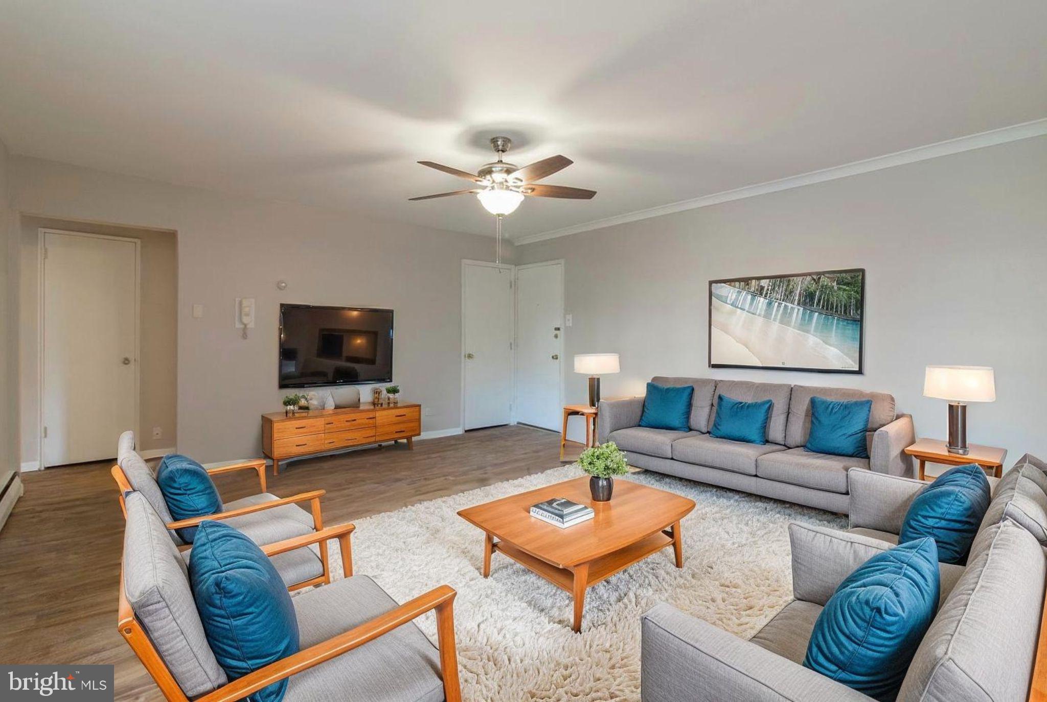 383 Lakeside Road, Unit 104 Ardmore, PA 19003 - Photo 1 of 18 a living room with furniture and a flat screen tv