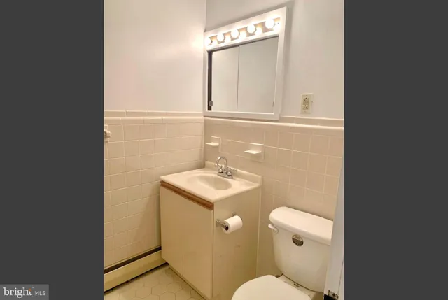 a bathroom with a sink a toilet and mirror